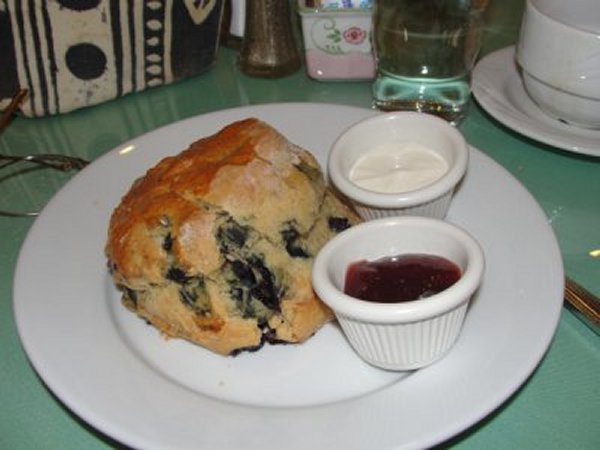 fruit filled scone with jelly and butter to the side