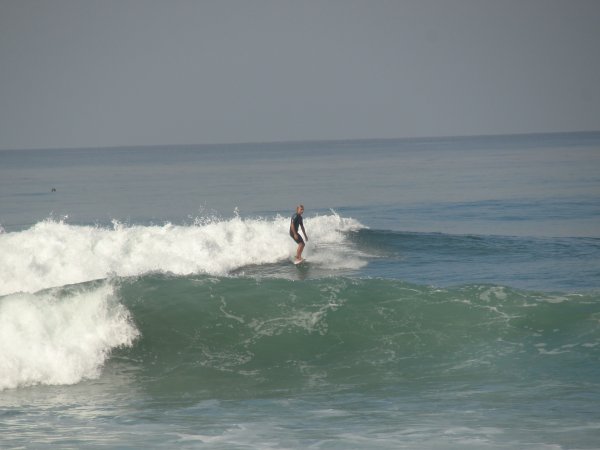 A Surfer catching a wave