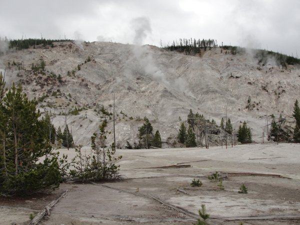 A cliff with steam coming out of it.